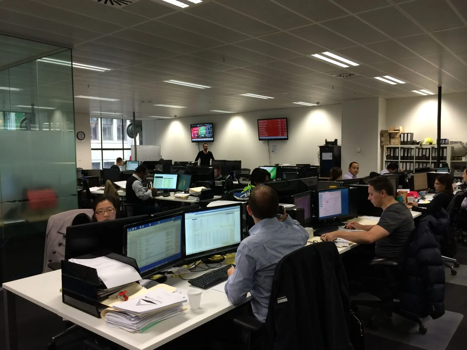 Trading desk floor with multiple market screens